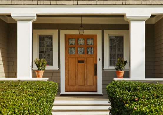 View of front door and porch of home