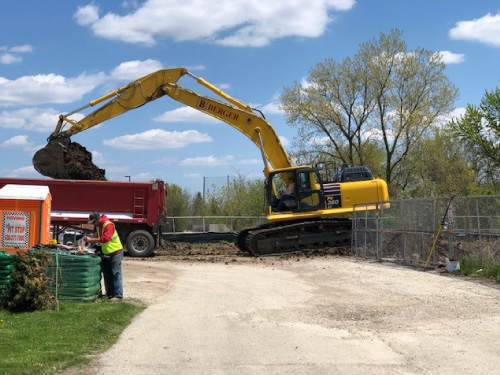 Backhoe moving dirt